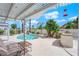 A backyard oasis featuring a swimming pool, tropical landscaping, a built-in grill, and a covered patio area at 3592 N Campbell Rd, Las Vegas, NV 89129