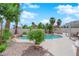 Backyard pool featuring mature landscaping and a rock waterfall, creating a relaxing outdoor space at 3592 N Campbell Rd, Las Vegas, NV 89129