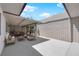 A furnished backyard with a sitting area with a loveseat and two chairs and a coffee table at 3667 Mckinley Ave, Las Vegas, NV 89121
