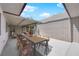 A furnished backyard with an outdoor dining table and chairs and a sitting area at 3667 Mckinley Ave, Las Vegas, NV 89121