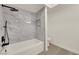 Modern bathroom featuring a tub with a white marble surround and black fixtures at 3667 Mckinley Ave, Las Vegas, NV 89121