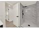Modern bathroom showcasing a glass-enclosed shower with sleek black fixtures and marble tile at 3667 Mckinley Ave, Las Vegas, NV 89121