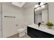Contemporary bathroom featuring a black vanity, modern lighting, and a large mirror at 3667 Mckinley Ave, Las Vegas, NV 89121
