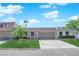 Charming single-story home with a well-manicured lawn and a two-car garage under a cloudy blue sky at 3667 Mckinley Ave, Las Vegas, NV 89121