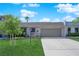 Inviting single-Gathering house featuring a lush green lawn, mature trees, and an attached two-car garage at 3667 Mckinley Ave, Las Vegas, NV 89121