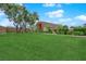 Lush green space with mature trees, landscaping, and seating areas at 3667 Mckinley Ave, Las Vegas, NV 89121