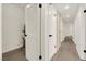 Hallway featuring fresh white walls and doors, black hardware, and a wooden-look floor at 3667 Mckinley Ave, Las Vegas, NV 89121