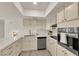 Tastefully designed kitchen with stainless steel appliances, light cabinetry, and stylish fixtures at 3667 Mckinley Ave, Las Vegas, NV 89121