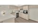 Charming kitchen with stainless steel appliances, light cabinetry, quartz countertops, and wood flooring at 3667 Mckinley Ave, Las Vegas, NV 89121