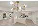 Open concept living space featuring an eat-in kitchen with stainless appliances, breakfast bar, and wood floors at 3667 Mckinley Ave, Las Vegas, NV 89121