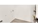 Bright laundry room with white walls, wooden-look floor, and new utility connections at 3667 Mckinley Ave, Las Vegas, NV 89121