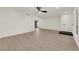 Bright living room with modern ceiling fan, wood floors, and neutral walls at 3667 Mckinley Ave, Las Vegas, NV 89121