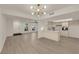 Spacious living area boasts a stylish light fixture, wood floors, and ample natural light from large windows at 3667 Mckinley Ave, Las Vegas, NV 89121