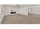 Expansive living area with a modern fireplace and contemporary flooring, leading into a dining area at 3667 Mckinley Ave, Las Vegas, NV 89121