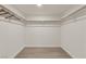 A bright and empty walk-in closet featuring wooden floors and a hanging rod at 3667 Mckinley Ave, Las Vegas, NV 89121