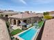 Aerial view showcasing the pool, patio, outdoor kitchen, and beautifully landscaped backyard of the home at 38 Costa Tropical Dr, Henderson, NV 89011