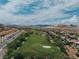 Panoramic view of a golf course community with mountain views and scenic desert landscape on a sunny day at 38 Costa Tropical Dr, Henderson, NV 89011