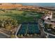 Aerial view of a community featuring pickleball courts, golf course, and houses at 38 Costa Tropical Dr, Henderson, NV 89011