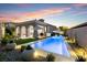 Stunning backyard with a pool, lounge chairs, manicured landscaping, and outdoor seating at 38 Costa Tropical Dr, Henderson, NV 89011