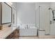 Modern bathroom featuring a soaking tub, glass-enclosed shower, and double vanity with sleek fixtures at 38 Costa Tropical Dr, Henderson, NV 89011