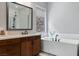 Bathroom featuring a soaking tub, glass-enclosed shower, and a stylish vanity with modern fixtures at 38 Costa Tropical Dr, Henderson, NV 89011