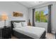 Serene bedroom with a comfortable bed, a nightstand, and a window view, creating a relaxing and inviting space at 38 Costa Tropical Dr, Henderson, NV 89011