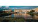 Picturesque view of the community buildings with a scenic lake and bridge at 38 Costa Tropical Dr, Henderson, NV 89011
