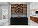 Elegant dining area with custom shelving, wine storage, and seamless flow to the adjacent kitchen and living spaces at 38 Costa Tropical Dr, Henderson, NV 89011