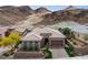 Stunning exterior of a house with a well-manicured front yard and mountain backdrop at 38 Costa Tropical Dr, Henderson, NV 89011