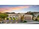 Elegant home featuring well-manicured landscaping, a paver driveway, and mountain views at 38 Costa Tropical Dr, Henderson, NV 89011