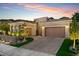 Attractive home with a paver driveway, two-car garage, and lush landscaping at 38 Costa Tropical Dr, Henderson, NV 89011