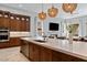 Bright, open kitchen featuring a large island, stainless appliances, and stylish pendant lighting at 38 Costa Tropical Dr, Henderson, NV 89011