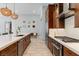Modern kitchen featuring stainless steel appliances, wooden cabinetry, and a large island with pendant lighting at 38 Costa Tropical Dr, Henderson, NV 89011