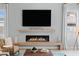 Modern living room with fireplace and mantle, decorative candle holders and hardwood flooring at 38 Costa Tropical Dr, Henderson, NV 89011