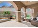 Covered patio with outdoor seating, fire pit, and scenic views of the surrounding mountains at 38 Costa Tropical Dr, Henderson, NV 89011