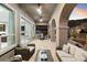 Covered patio with comfortable seating, ceiling fans and outdoor kitchen with natural stone pavers at 38 Costa Tropical Dr, Henderson, NV 89011