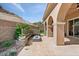 Inviting outdoor patio with a modern fire pit, comfortable seating, and privacy landscaping at 38 Costa Tropical Dr, Henderson, NV 89011