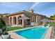Beautiful backyard with a refreshing pool, patio area, and outdoor kitchen perfect for entertaining guests at 38 Costa Tropical Dr, Henderson, NV 89011
