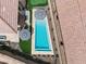 Aerial view of a backyard pool, outdoor kitchen with black and white striped umbrellas and desert landscaping at 38 Costa Tropical Dr, Henderson, NV 89011