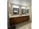 Bathroom with granite countertops, double sinks, modern lighting, and ample cabinet space at 390 Rushing Creek Ct, Henderson, NV 89014