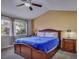 Bedroom features a large window, ceiling fan and bedside table with lamp at 390 Rushing Creek Ct, Henderson, NV 89014