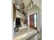 Bright foyer featuring a stained-glass window, chandelier, tiled floor, and stairway to second floor at 390 Rushing Creek Ct, Henderson, NV 89014