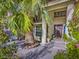 Inviting front porch with mature palms, seating, and meticulously maintained landscaping at 390 Rushing Creek Ct, Henderson, NV 89014