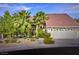 Charming single-story home with desert landscaping, mature palms, and a two-car garage at 390 Rushing Creek Ct, Henderson, NV 89014