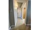 Tiled hallway with access to a white door and built-in wooden cabinets at 390 Rushing Creek Ct, Henderson, NV 89014