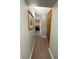 Hallway with carpeted floor, a framed picture, and built-in wooden cabinets at 390 Rushing Creek Ct, Henderson, NV 89014