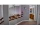 Hallway with view into the bathroom featuring a vanity and mirror at 390 Rushing Creek Ct, Henderson, NV 89014