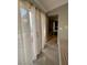 Hallway featuring tile floors, curtains, and an open doorway to another room at 390 Rushing Creek Ct, Henderson, NV 89014