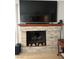 Cozy living room fireplace with stone surround and a large-screen TV mounted above at 390 Rushing Creek Ct, Henderson, NV 89014