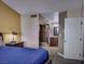 Bright main bedroom featuring an ensuite bath and shower, complete with a bedside table and lamp at 390 Rushing Creek Ct, Henderson, NV 89014